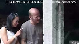 two girls engage in a fierce catfight inside a wrecked car in the junkyard