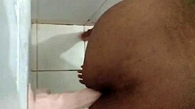 Amateurs experiment with dildo in the bathroom setting.