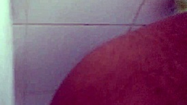 Amateurs experiment with dildo in the bathroom setting.