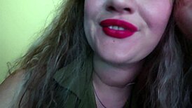 Cute woman paints her lips red and smokes a cigarette. I hope you like it.