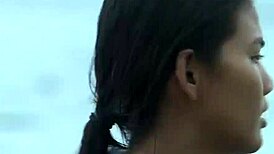 Croc sexy bikini girl posing on the beach with a playful twist