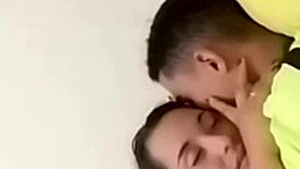 sexy couple lounging in bed sharing laughs and cuddles with soft music playing in the background