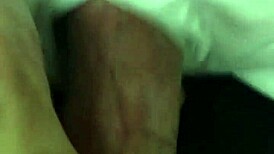 Mature woman receives oral attention in a subtle intimate setting.