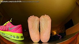 Tall girl shows sexy barefoot feet in Nike shoes for foot fetish domination