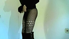 Transsexual crossdresser in black boots showing off shemale features