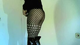 Transsexual crossdresser in black boots showing off shemale features
