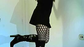Transsexual crossdresser in black boots showing off shemale features