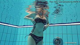 Redheaded Katrin Strips Underwater in Teasing Solo with Ripped Clothes and Tattoos