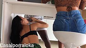 Naughty wife teases husband in kitchen while friend chats