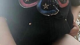 Woman gets fucked with dildo in the forest, moaning loudly.