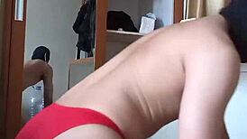 Sexy gay in red cd and mask plays with toys