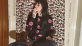 smoking goth girl relaxes behind the scene after a long day?