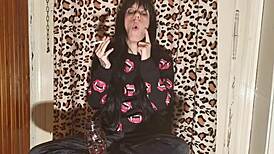 smoking goth girl relaxes behind the scene after a long day?