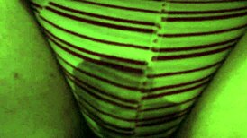 The girl pees in her red striped underpants on the toilet