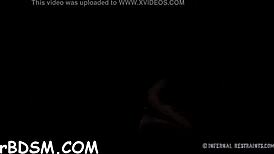 The caged brunette babe eagerly gives a blowjob in BDSM play