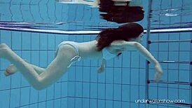 Roxalana Cheh feels the thrill as sexy redhead underwater with tight shaved ass