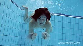 Roxalana Cheh feels the thrill as sexy redhead underwater with tight shaved ass