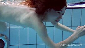 Roxalana Cheh feels the thrill as sexy redhead underwater with tight shaved ass