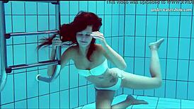 Teen brunette's hot tits and shaved pussy underwater.