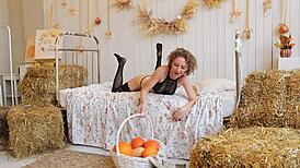 Red-haired curly woman in black stockings on halloween kitchen