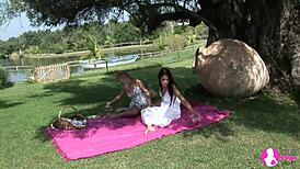 Blonde and brunette lesbians engage in passionate kissing and ass licking in the garden