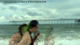 Beautiful women in bikinis at the beach in a photo shoot.