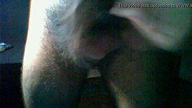 A detailed scene of hairy dick masturbation featuring a man stroking his thick, hairy cock in close-up view