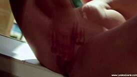 Anna Simone and her partner share a kiss in the outdoors