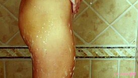 Eighteen-year-old blonde enjoys a relaxing hot shower