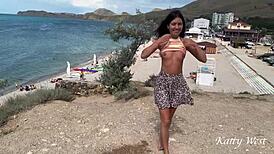 Brunette masturbates nude ass in public beach pee