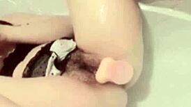 Asian girl masturbates in bathroom watching porn with dildo