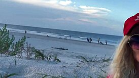 This hot milf was masturbating on the public beach with people watching her closely.