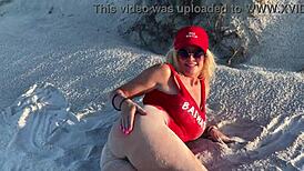 This hot milf was masturbating on the public beach with people watching her closely.