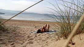 Filming a curvy European babe doing exercises and changing on the public beach