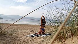 Filming a curvy European babe doing exercises and changing on the public beach