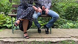Chubby mother-in-law gives handjob outdoors in park.