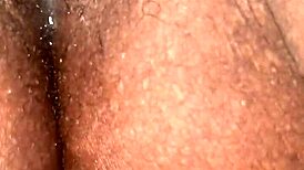 wet dripping creamy pussy on display, inviting exploration with its ebony curves and hairy allure