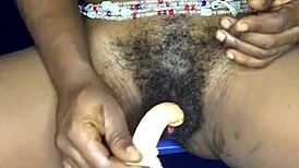 That sexy ebony girl from Ghana is using a dildo on her pussy and ass.