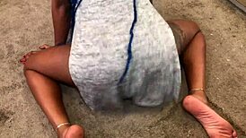 Twerking reveals panties under skirt in teasing upskirt display.
