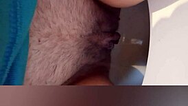 Greta goes to the bathroom and then warms up under the blanket