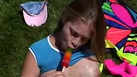 Teen Little April rubs her clit outdoors while sucking a popsicle. She’s all alone showing off.