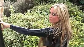 Blonde latex babe Amanda struts outdoor in tight rubber boots