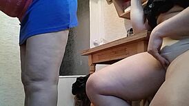 Amateur masturbates in kitchen next to stepmother, risking orgasm