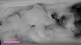 Kitty Hudson enjoys a relaxing bath with a toy