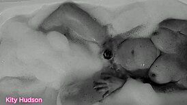 Kitty Hudson enjoys a relaxing bath with a toy