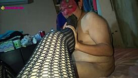 in this scene, a latina milf prostitute in lingerie and high heels gives a footjob with her fishnet clad feet