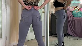 sexy milf tabithaxxx tries on tight gym leggings in bedroom, flashing curvy body and big natural tits for pov fans during sfw haul.