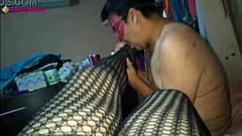 in this scene, a latina milf prostitute in lingerie and high heels gives a footjob with her fishnet clad feet