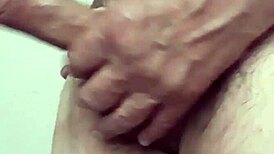 The bear guy jerks off with his huge cock, moaning loudly.