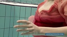 Katya Okuneva looks stunning in her red dress by the pool.